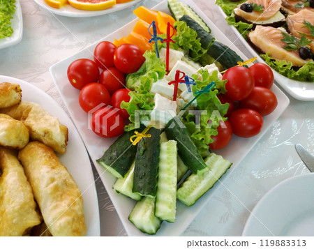 Fresh vegetables and cheese on a set banquet table 119883313