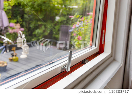 View from the window to the garden in the summer on a sunny day. Ajar window. 119883717