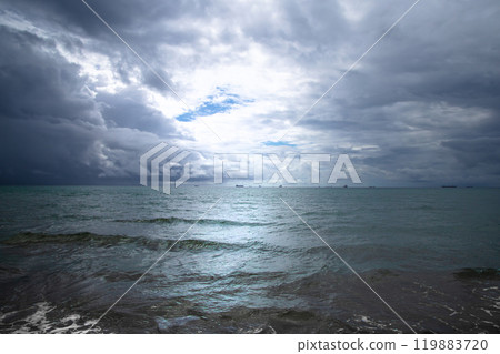 Beautiful dark evening sea and sky with dark clouds through which light passes. Beautiful dark evening sea and sky with dark clouds through which light passes. 119883720
