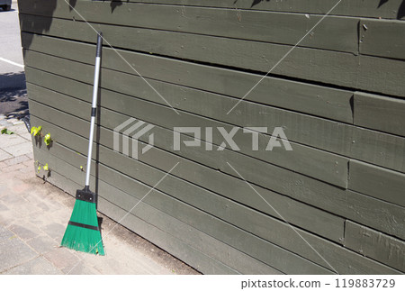 Broom on clean street, outdoors cleaning. City cleaning service. 119883729