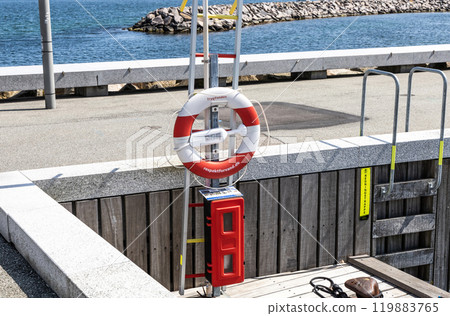 Lifebuoy hang on the pier. Concept of a safe holiday. 119883765