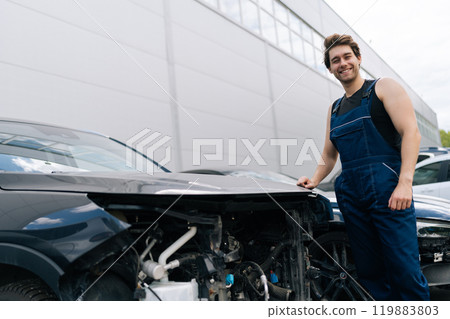 Friendly skilled mechanic providing thorough repair estimate for damaged vehicle, prioritizing safety and excellence in automotive service. Concept of professional automobile maintenance. Friendly skilled mechanic providing thorough repair estimate for damaged vehicle, prioritizing safety and excellence in automotive service. Concept of professional automobile maintenance. 119883803