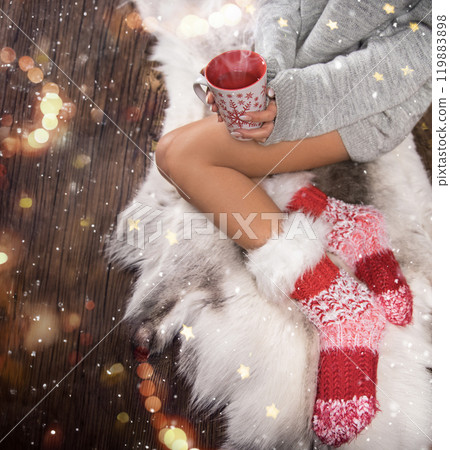 Christmas time concept. Pretty woman holding red mug with beverage 119883898