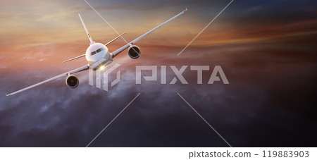 View from the cockpit of the plane to the beautiful clouds during sunset 119883903