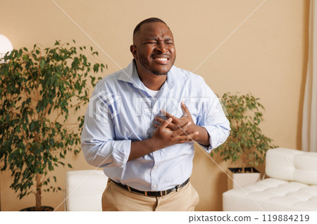 Man touching heart with heart disease concept suffering Contractions and difficulty breathing Chest pain or heart attack, life insurance, health care concept Man touching heart with heart disease concept suffering Contractions and difficulty breathing Chest pain or heart attack, life insurance, health care concept 119884219