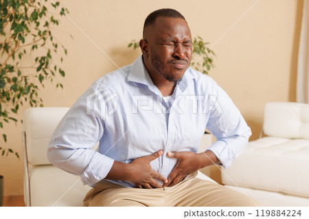 Intestinal inflammation. Irritable Bowel Syndrome. Man touching stomach, suffering painful of stomachache, gastrointestinal system desease cause of stress from work. Health insurance care concept Intestinal inflammation. Irritable Bowel Syndrome. Man touching stomach, suffering painful of stomachache, gastrointestinal system desease cause of stress from work. Health insurance care concept 119884224
