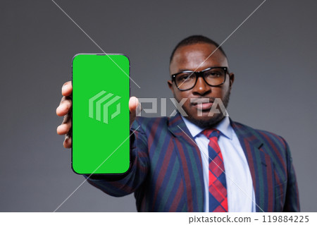 A man holding a green screen phone with a formal attire, perfect for stock footage or creative projects, space for text A man holding a green screen phone with a formal attire, perfect for stock footage or creative projects, space for text 119884225