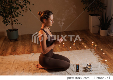 Yoga meditation at home. girl doing aromatherapy and meditation at home, stay calm and be happy. Aromatherapy 119884231