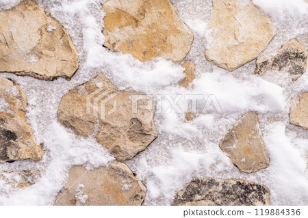 Rustic winter stone path covered in snowflakes. Rustic winter stone path covered in snowflakes. 119884336