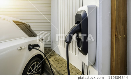 Electric car charging at residential home station 119884844