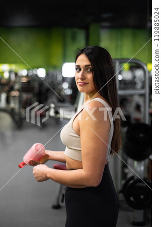 Young woman relax after exhausting training, Young athlete drinking sports drink after workout. Young woman relax after exhausting training, Young athlete drinking sports drink after workout. 119885024