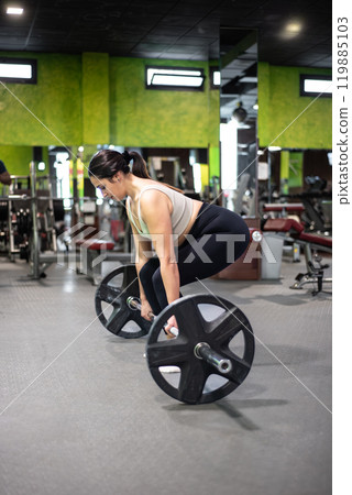 Young caucasian woman doing deadlift in the gym. 119885103