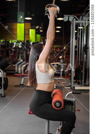 Fitness woman doing back exercises in gym. Fitness woman doing back exercises in gym. 119885566