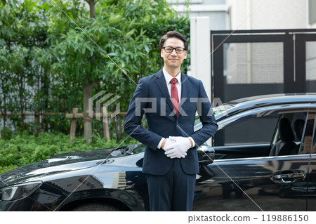 Driver standing in front of the car 119886150