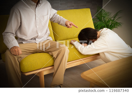 A middle-aged to senior couple arguing in the living room at home 119887340
