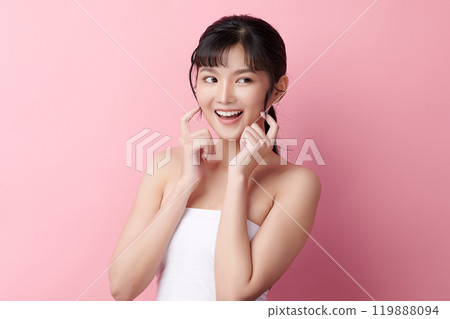Beautiful young asian woman with clean fresh skin on pink background, Face care, Facial treatment, Cosmetology, beauty and spa, Asian women portrait. Beautiful young asian woman with clean fresh skin on pink background, Face care, Facial treatment, Cosmetology, beauty and spa, Asian women portrait. 119888094