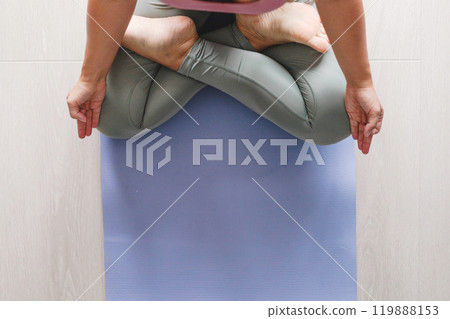 Yoga woman legs sitting mat lotus position with mudra gyan gyana jnana hands closeup top view 119888153