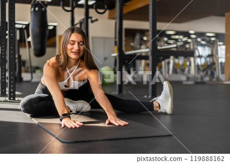 Athletic fitness woman stretching body at gym enjoy physical exercise activity 119888162