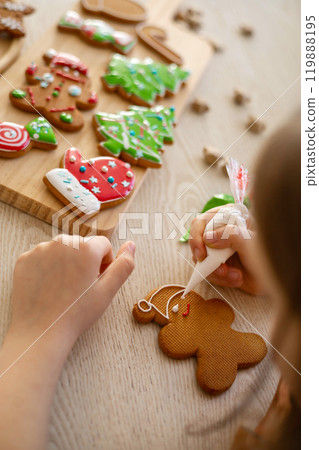 Merry Christmas and Happy Holidays. Boy cooking Christmas gingerman cookies. 119888195