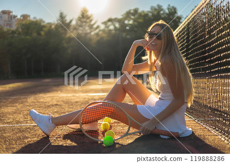Portrait smiling woman tennis player posing with balls in hand heart shape at outdoor court closeup Portrait smiling woman tennis player posing with balls in hand heart shape at outdoor court closeup 119888286