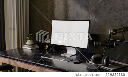 A modern freelance podcaster office workspace featuring a computer, headphones, and a microphone. 119889180