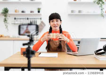 Caucasian female blogger creating online unboxing video at home 119889416