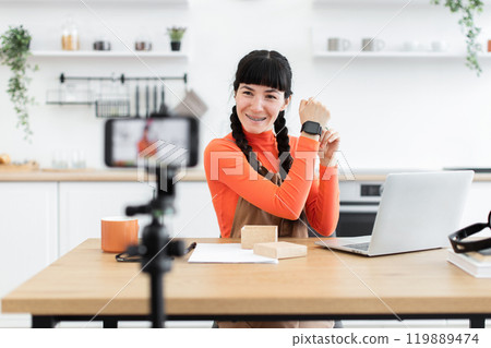 Young woman reviews smartwatch for popular online blog channel 119889474