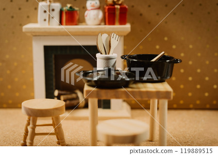 A warm kitchen scene with Christmas decorations and a fireplace A warm kitchen scene with Christmas decorations and a fireplace 119889515