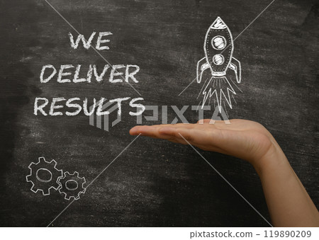 A hand holding a chalkboard with the words We deliver results written on it 119890209