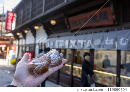 Holding a traditional hot spring manju from Kusatsu Onsen Holding a traditional hot spring manju from Kusatsu Onsen 119890804