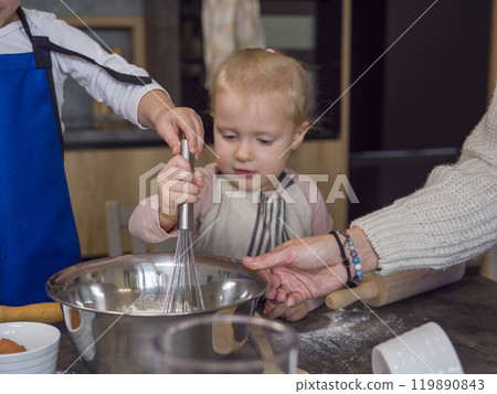 Mother and children joyfully making cookies in contemporary kitchen. Creating special treats together with love and care, building skills and traditions for happy life concept of cooking food Mother and children joyfully making cookies in contemporary kitchen. Creating special treats together with love and care, building skills and traditions for happy life concept of cooking food 119890843