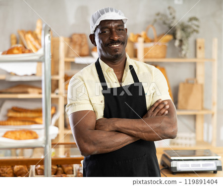 Portrait of positive man baker 119891404