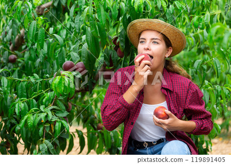 Young woman eating ripe peach 119891405