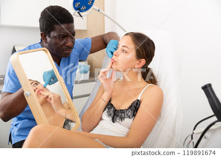 Doctor giving consultation about injection for lips to female patient Doctor giving consultation about injection for lips to female patient 119891674