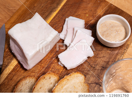 Traditional russian and ukrainian food, salted smoked pork bacon with horseradish on wooden cutting board 119891760