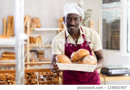 Portrait of positive man bakery worker 119891907