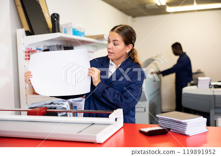 Worker in printing and press centar check print quality 119891952