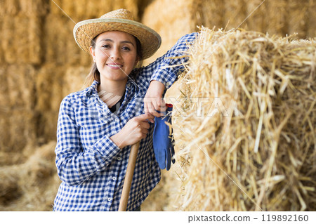 Latino american female farmer standing at the cow farm 119892160