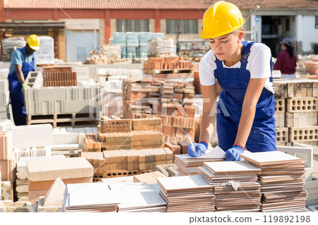 Girl worker keeps records of ceramic tiles Girl worker keeps records of ceramic tiles 119892198