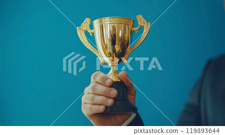 Man holding a gold trophy Man holding a gold trophy 119893644