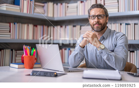 teacher at lesson during estudy. digital classroom. Online education of teacher in classroom. teachers day. teacher man offer education online. online school education. Online classes teacher at lesson during estudy. digital classroom. Online education of teacher in classroom. teachers day. teacher man offer education online. online school education. Online classes 119893925