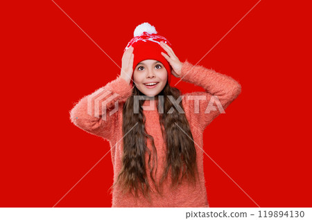 Childhood winter memories. Teen girl kid isolated on red studio. Child winter fashion. Girl enjoying winter style. Teen girl wearing stylish new year hat. Knitted accessories 119894130