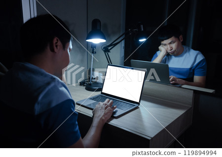 bored man working with laptop at night (with clipping path) 119894994