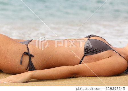Beauty woman body in bikini sunbathing on the beach 119897245