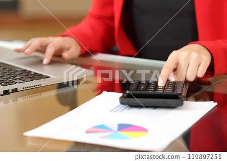 Businesswoman accounting with calculator and laptop Businesswoman accounting with calculator and laptop 119897251