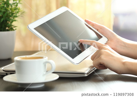 Girl hands using a tablet at home 119897308
