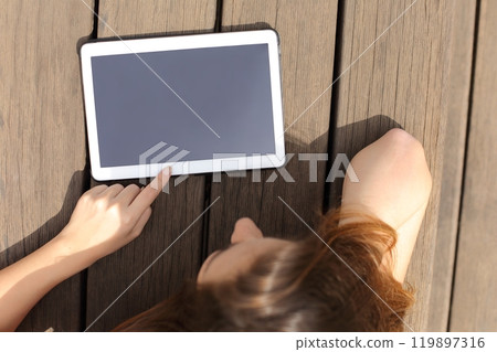 Girl using and showing a blank tablet screen 119897316
