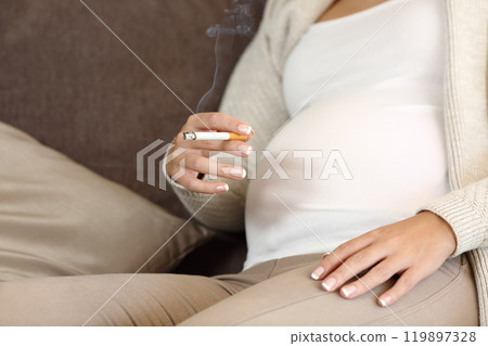 Irresponsible pregnant woman smoking a cigar 119897328