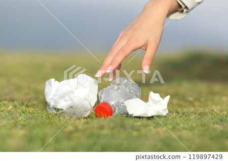 Woman hand collecting garbage in the mountain 119897429