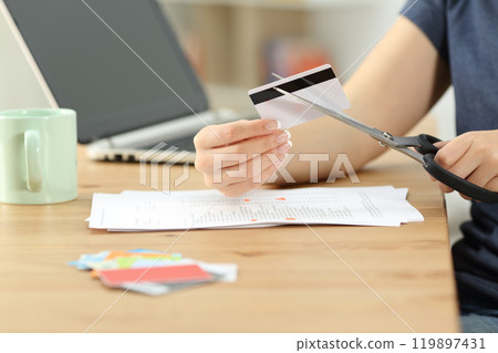 Woman hand destroying old credit cards 119897431
